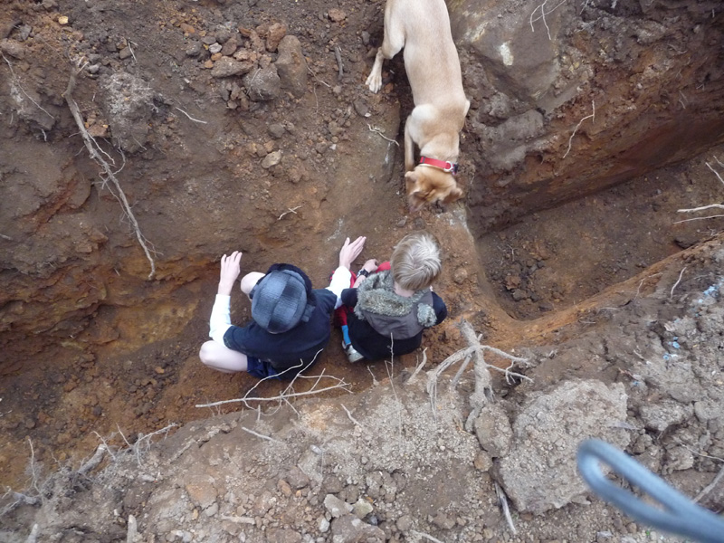 Grandsons and dog in trench