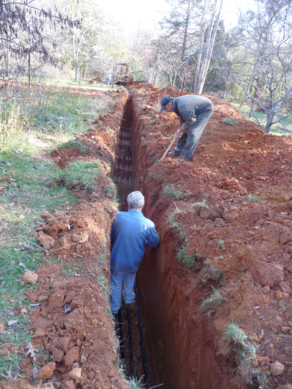 Laying the geothermal lines in the trench
